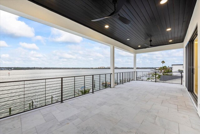 820 Bay Point Dr, Madeira Beach, FL 33708 - balcony with a water view, ceiling fan, and a sunroom
