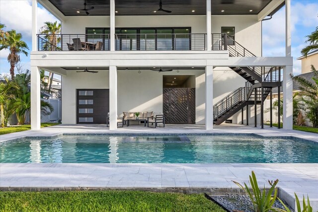 820 Bay Point Dr, Madeira Beach, FL 33708 - back of property with ceiling fan, a balcony, stairs, and a patio area