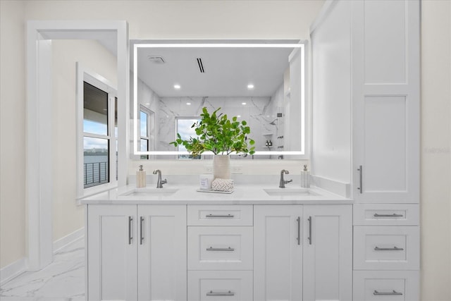 820 Bay Point Dr, Madeira Beach, FL 33708 - bathroom featuring marble finish flooring, double vanity, a marble finish shower, baseboards, and recessed lighting