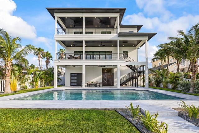 820 Bay Point Dr, Madeira Beach, FL 33708 - rear view of house with ceiling fan, a balcony, stairs, stucco siding, and a patio area