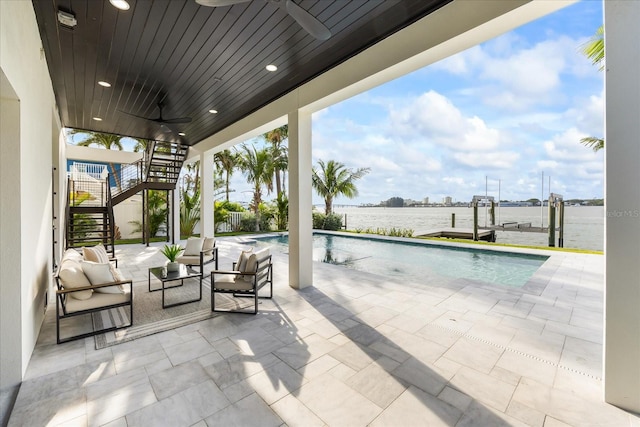 820 Bay Point Dr, Madeira Beach, FL 33708 - view of patio with stairs, a ceiling fan, an outdoor pool, a water view, and boat lift