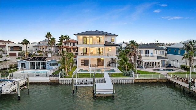 820 Bay Point Dr, Madeira Beach, FL 33708 - back of property featuring a balcony, a patio, a water view, and a residential view