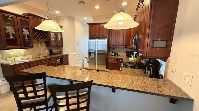 7810 Whitemarsh Way, Reunion, FL 34747 - kitchen featuring stainless steel appliances, a peninsula, a sink, tasteful backsplash, and glass insert cabinets