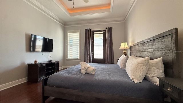 7810 Whitemarsh Way, Reunion, FL 34747 - bedroom featuring a tray ceiling, baseboards, wood finished floors, and ornamental molding