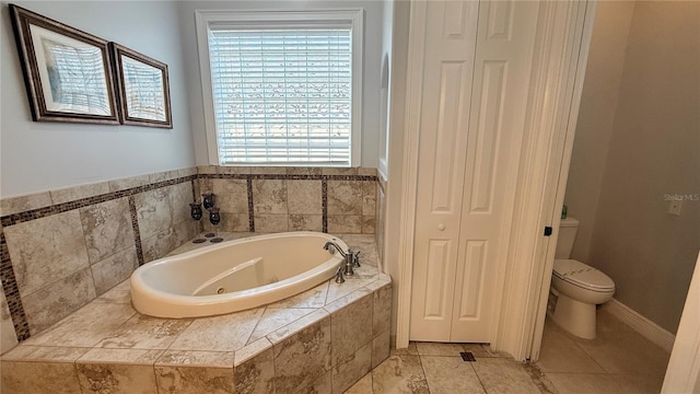 7810 Whitemarsh Way, Reunion, FL 34747 - bathroom featuring a closet, a jetted tub, toilet, and tile patterned flooring