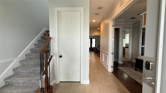 7810 Whitemarsh Way, Reunion, FL 34747 - stairs with ornamental molding, tile patterned floors, wainscoting, and recessed lighting
