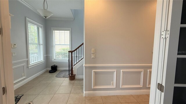7810 Whitemarsh Way, Reunion, FL 34747 - foyer with ornamental molding, light tile patterned flooring, stairs, and baseboards