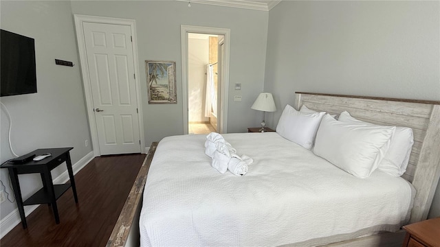 7810 Whitemarsh Way, Reunion, FL 34747 - bedroom featuring dark wood-type flooring, baseboards, ornamental molding, and connected bathroom