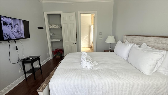 7810 Whitemarsh Way, Reunion, FL 34747 - bedroom featuring dark wood-style flooring, ornamental molding, a walk in closet, baseboards, and a closet