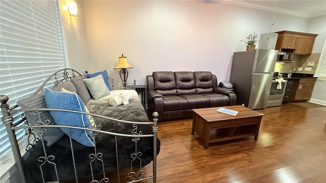 7810 Whitemarsh Way, Reunion, FL 34747 - living area with crown molding, wood finished floors, and healthy amount of natural light