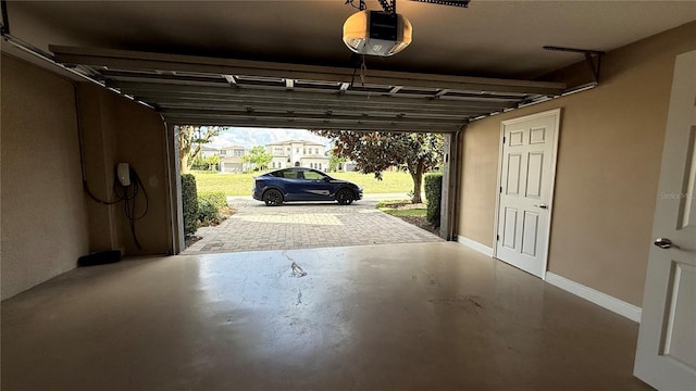 7810 Whitemarsh Way, Reunion, FL 34747 - garage featuring a garage door opener and baseboards