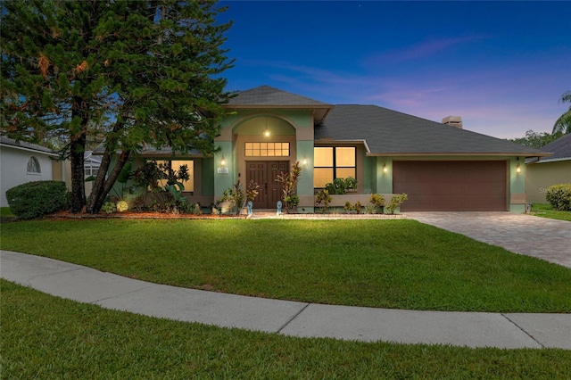 6621 Appaloosa Dr, Tampa, FL 33625 - view of front of home with stucco siding, a garage, decorative driveway, and a front yard