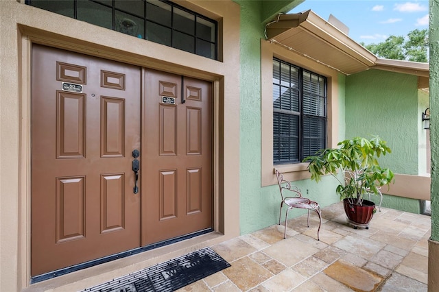 6621 Appaloosa Dr, Tampa, FL 33625 - entrance to property with stucco siding and a porch