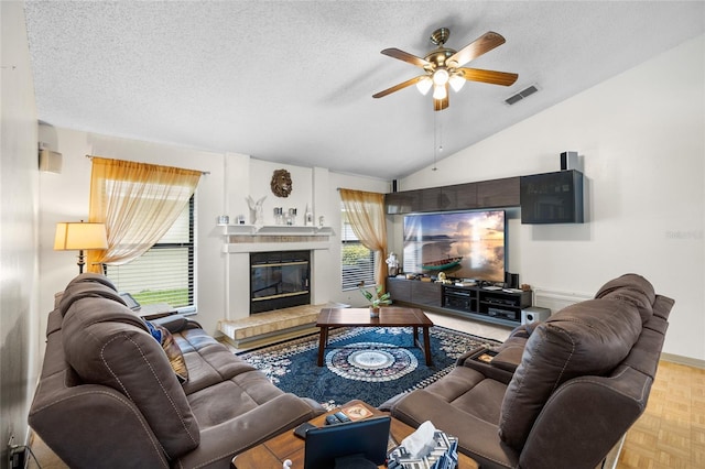 6621 Appaloosa Dr, Tampa, FL 33625 - living area featuring a ceiling fan, a textured ceiling, lofted ceiling, and a tiled fireplace