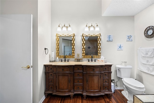 6621 Appaloosa Dr, Tampa, FL 33625 - bathroom with wood finished floors, double vanity, toilet, and baseboards