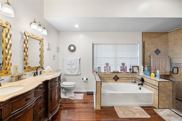 6621 Appaloosa Dr, Tampa, FL 33625 - full bathroom featuring a bath, a stall shower, double vanity, wood finished floors, and toilet