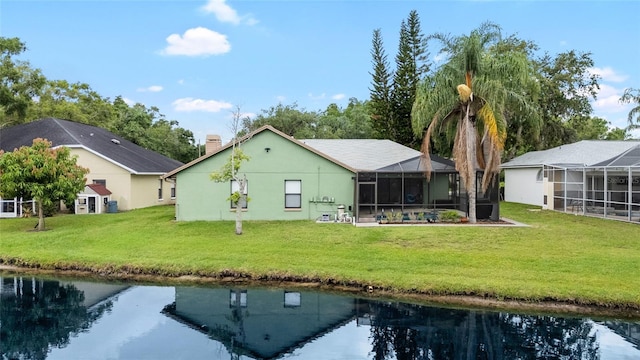 6621 Appaloosa Dr, Tampa, FL 33625 - rear view of property with a lawn, a water view, glass enclosure, and a chimney