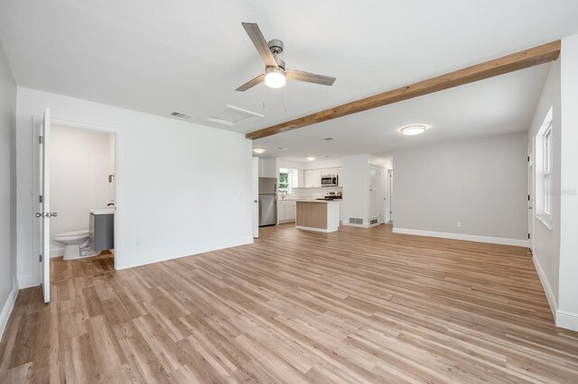 109 Magnolia Ave, Seffner, FL 33584 - unfurnished living room featuring attic access, light wood-style flooring, beam ceiling, and ceiling fan