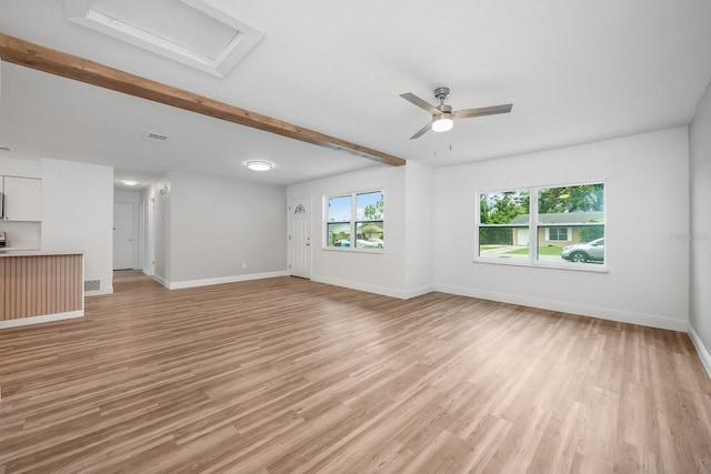 109 Magnolia Ave, Seffner, FL 33584 - unfurnished living room featuring light wood-style floors, a ceiling fan, beamed ceiling, and attic access