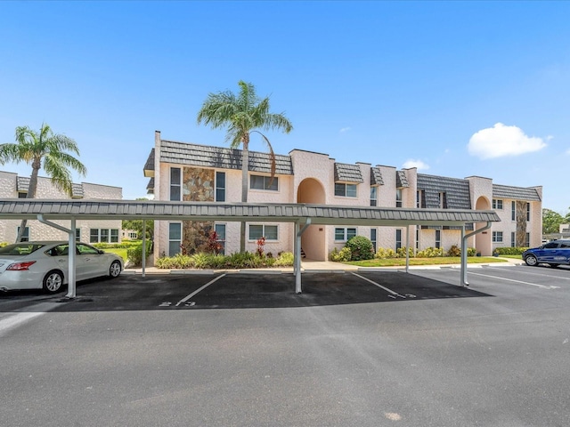 213 Fernwood Cir Unit 213, Seminole, FL 33777 - view of building exterior with covered parking