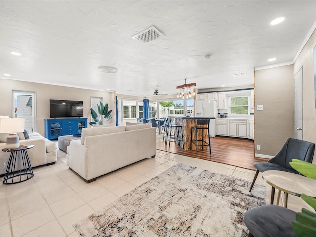 213 Fernwood Cir Unit 213, Seminole, FL 33777 - living area with light tile patterned flooring, ornamental molding, and recessed lighting