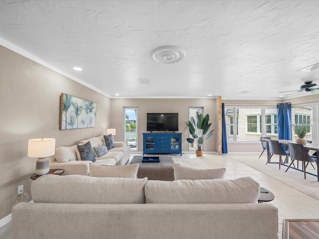 213 Fernwood Cir Unit 213, Seminole, FL 33777 - living area with plenty of natural light, crown molding, baseboards, and tile patterned flooring