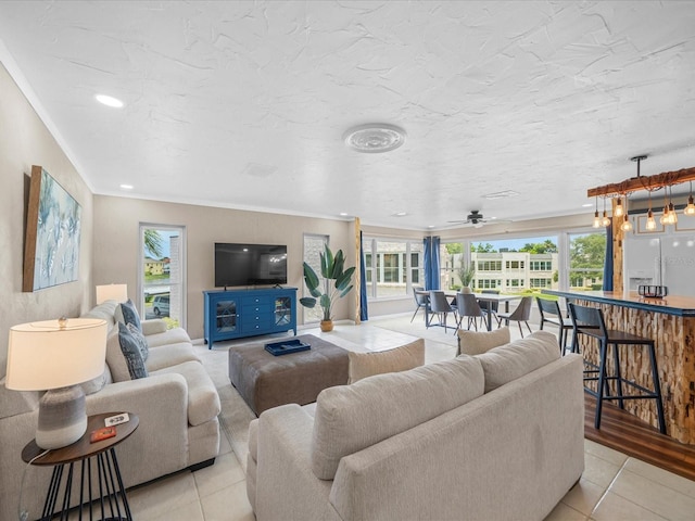 213 Fernwood Cir Unit 213, Seminole, FL 33777 - living area featuring light tile patterned floors and ornamental molding