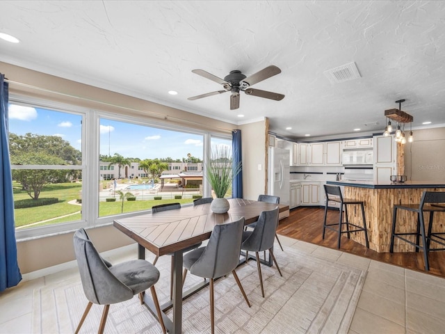 213 Fernwood Cir Unit 213, Seminole, FL 33777 - dining space featuring recessed lighting, ceiling fan, crown molding, light tile patterned flooring, and baseboards