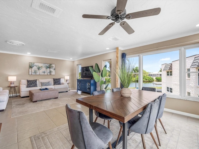 213 Fernwood Cir Unit 213, Seminole, FL 33777 - dining area featuring light tile patterned floors, baseboards, recessed lighting, ceiling fan, and crown molding