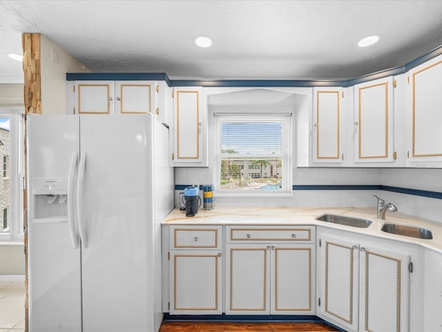 213 Fernwood Cir Unit 213, Seminole, FL 33777 - kitchen featuring white fridge with ice dispenser, a sink, and light countertops