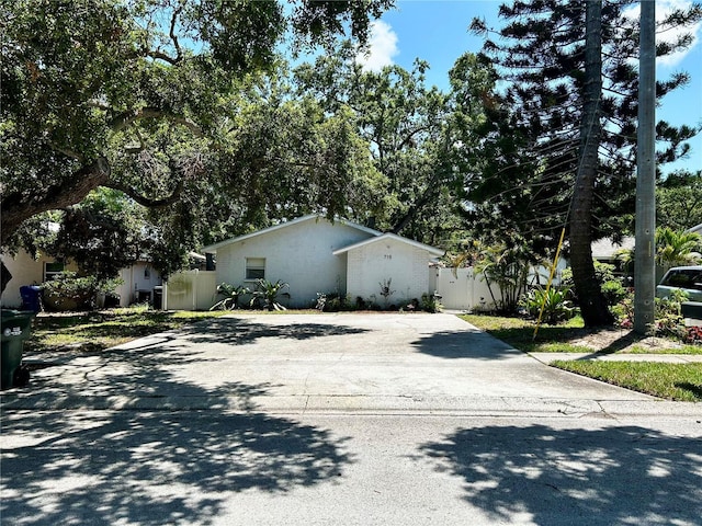 715 2nd Ave NE, Largo, FL 33770 - view of side of home with concrete driveway and stucco siding