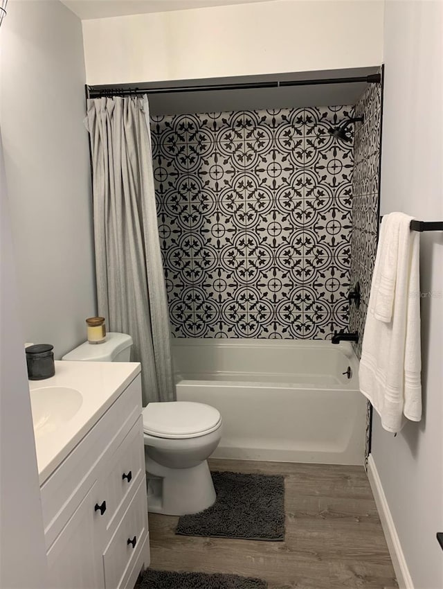 715 2nd Ave NE, Largo, FL 33770 - bathroom with wood finished floors, shower / bath combo, vanity, and toilet