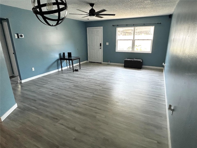 715 2nd Ave NE, Largo, FL 33770 - unfurnished room with ceiling fan, a textured ceiling, wood finished floors, and baseboards