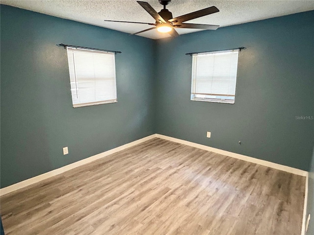 715 2nd Ave NE, Largo, FL 33770 - empty room with a textured ceiling, a ceiling fan, wood finished floors, and baseboards