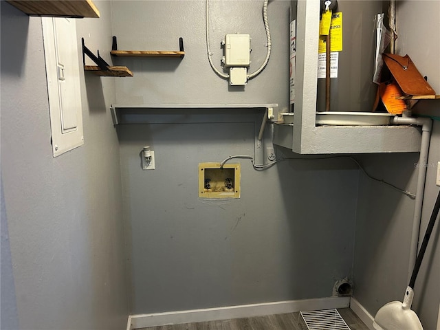 715 2nd Ave NE, Largo, FL 33770 - laundry area with electric dryer hookup, washer hookup, baseboards, wood finished floors, and water heater