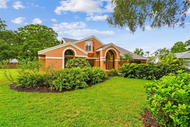 3308 Landing Pl, Palm Harbor, FL 34684 - view of front facade with stucco siding and a front yard