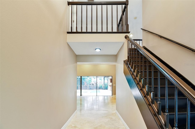 3308 Landing Pl, Palm Harbor, FL 34684 - stairway featuring baseboards and a towering ceiling