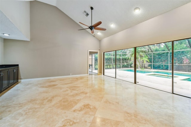 3308 Landing Pl, Palm Harbor, FL 34684 - unfurnished living room with ceiling fan, high vaulted ceiling, healthy amount of natural light, baseboards, and recessed lighting