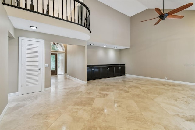 3308 Landing Pl, Palm Harbor, FL 34684 - empty room with high vaulted ceiling, a ceiling fan, and baseboards