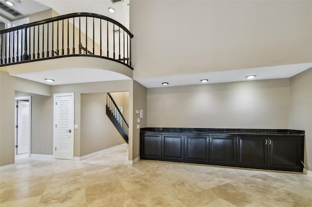 3308 Landing Pl, Palm Harbor, FL 34684 - interior space featuring stairs, a towering ceiling, baseboards, and recessed lighting