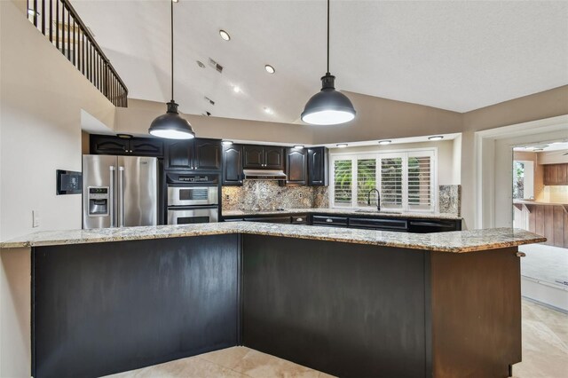 3308 Landing Pl, Palm Harbor, FL 34684 - kitchen featuring stainless steel appliances, lofted ceiling, a sink, tasteful backsplash, and under cabinet range hood