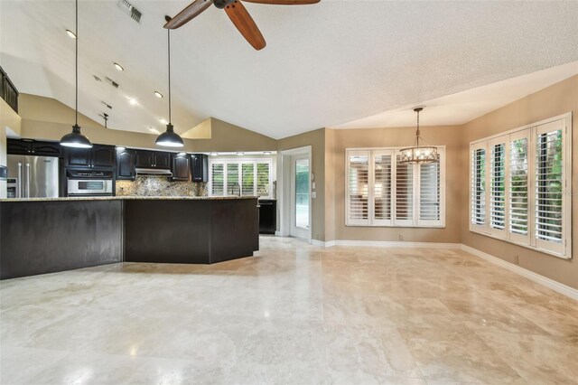 3308 Landing Pl, Palm Harbor, FL 34684 - kitchen with stainless steel appliances, vaulted ceiling, a ceiling fan, a chandelier, and backsplash