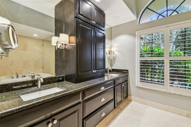 3308 Landing Pl, Palm Harbor, FL 34684 - bathroom featuring double vanity, tile patterned flooring, and baseboards