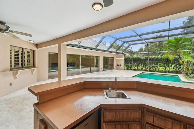 3308 Landing Pl, Palm Harbor, FL 34684 - outdoor pool with exterior kitchen, a sink, ceiling fan, a patio area, and a lanai