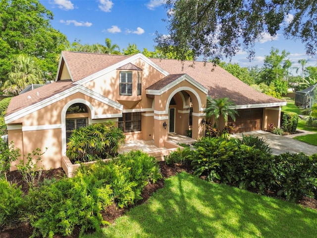 3308 Landing Pl, Palm Harbor, FL 34684 - view of front of property with a shingled roof, stucco siding, concrete driveway, and a front lawn