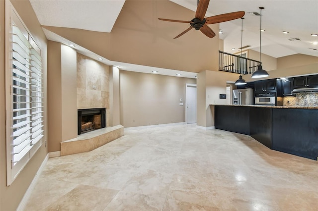 3308 Landing Pl, Palm Harbor, FL 34684 - unfurnished living room featuring baseboards, a fireplace, ceiling fan, high vaulted ceiling, and recessed lighting