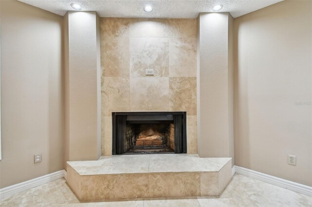 3308 Landing Pl, Palm Harbor, FL 34684 - detailed view of a tiled fireplace, recessed lighting, baseboards, and a textured ceiling