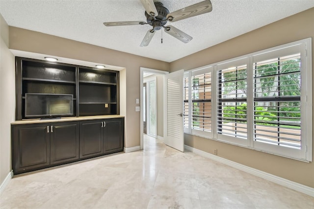 3308 Landing Pl, Palm Harbor, FL 34684 - unfurnished living room featuring a textured ceiling, baseboards, and a ceiling fan