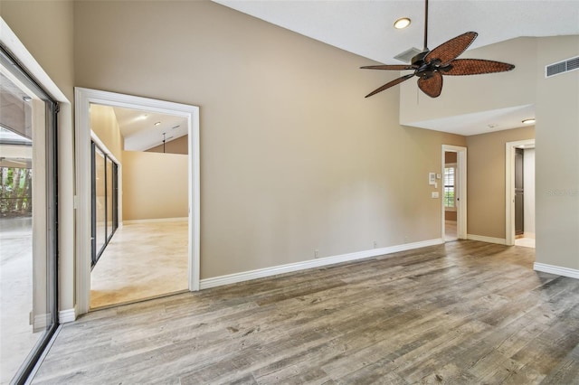 3308 Landing Pl, Palm Harbor, FL 34684 - empty room with plenty of natural light, wood finished floors, high vaulted ceiling, ceiling fan, and baseboards