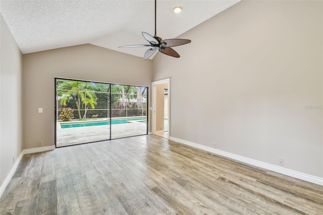 3308 Landing Pl, Palm Harbor, FL 34684 - empty room featuring ceiling fan, wood finished floors, vaulted ceiling, and baseboards